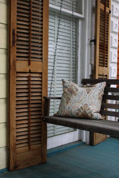 istock an old wooden porch swing and window shutters 1285486437