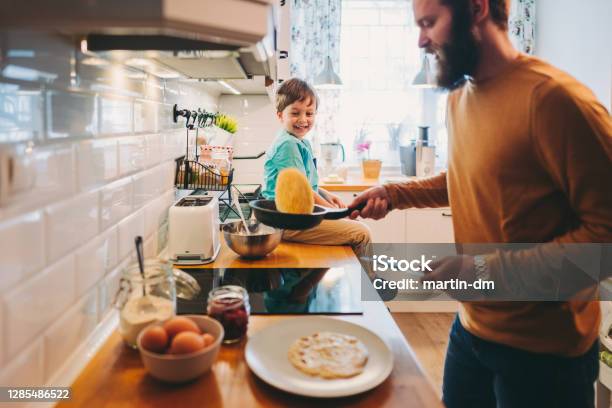 Single Father Preparing Pancakes During Covid19 Lockdown Stock Photo - Download Image Now