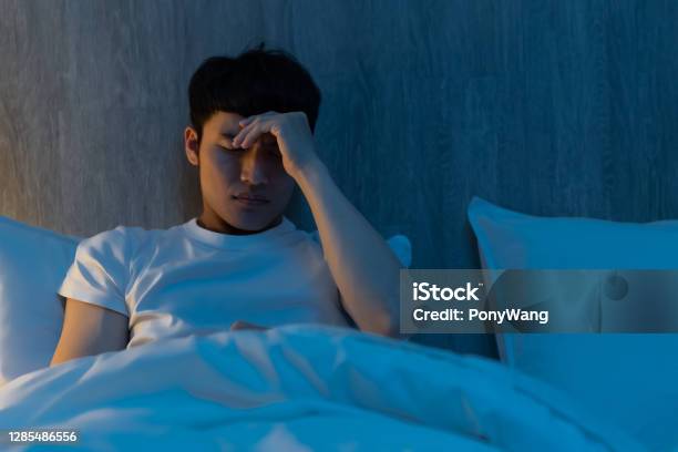 Worried Man On Bed Stock Photo - Download Image Now - Insomnia, Men, Japanese Ethnicity