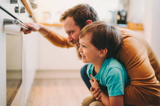 istock Father with son cooking dinner together 1285487462