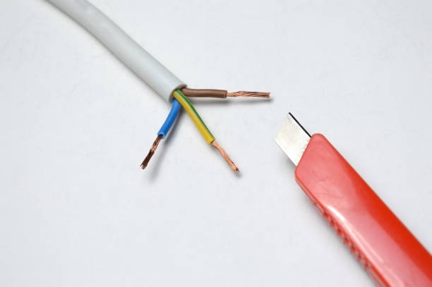 istock stripped three-wire, electric cable and stationery knife 1285487706