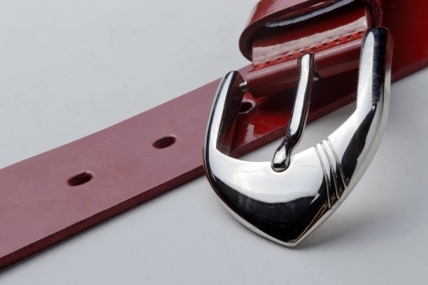 istock red women's belt with a chrome plaque on a white background. close-up. 1285488094