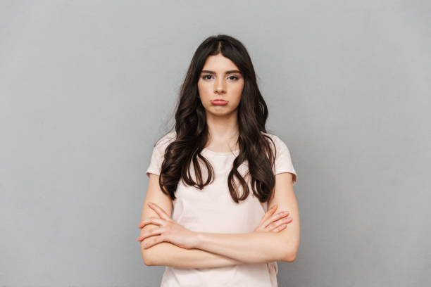 istock Displeased sad young lady standing isolated 1285488846