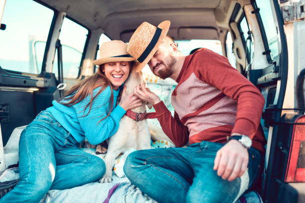 istock Couple Enjoying Time Spent With Dog In Minivan Back 1285488925