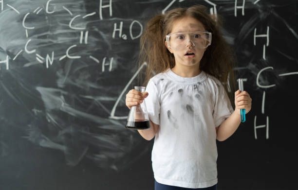 istock Little girl makes experiments in chemistry lesson. Explosion during the experiment. 1285489139
