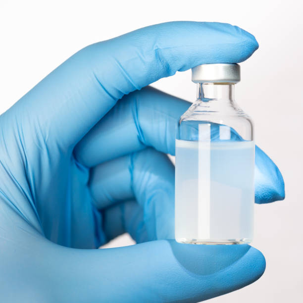 istock Holding a vaccine vial 1285489302