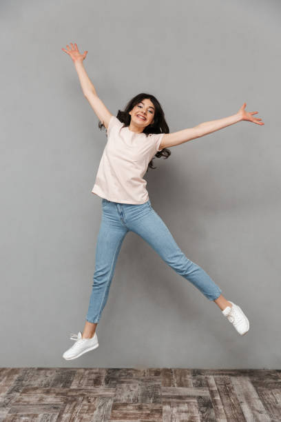 istock Excited young lady jumping isolated 1285489502
