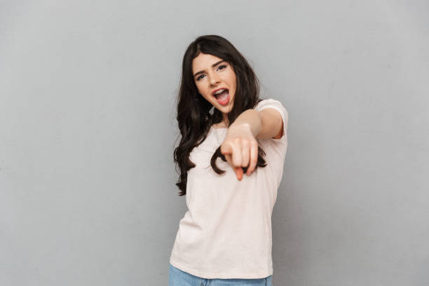 istock Beautiful young lady pointing to you. 1285489558