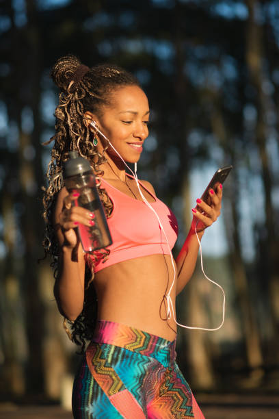 istock Fitness black woman using smart phone 1285490413
