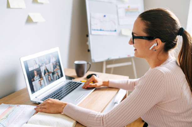 istock Woman using app for video call to several people 1285491092
