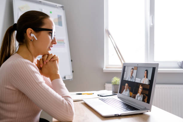 istock Woman using app for video call to several people 1285491133