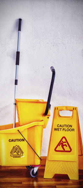 istock Yellow sign board with mop bucket on floor against wall 1285491973