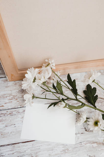 istock white sheet for text and fresh branch with white flowers on a light wooden background 1285492128
