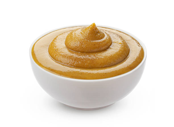 istock Mustard in bowl isolated on white background 1285492393