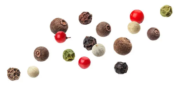 Falling Pepper mix of black, red, white and allspice peppercorns isolated on white background with clipping path
