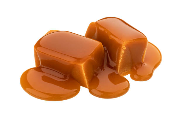 istock Caramel candy and caramel sauce isolated on white background 1285492441