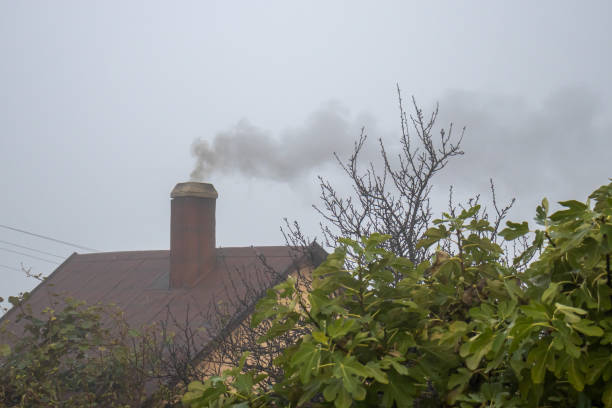 A smoking chimney on an autumn morning