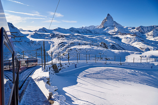 Train point view of Matterhorn reflection blue sky at winter sunny, Switzerland Alps.
