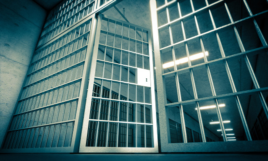 prison in penitentiary with bars and open door. 3d render. nobody around.