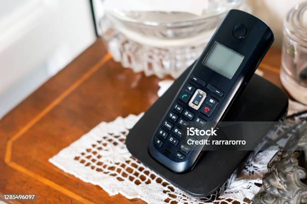 An Old Cordless Telephone On Its Charging Cradle Stock Photo - Download Image Now - Landline Phone, Telephone, Home Interior
