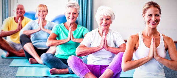 istock Instructor performing yoga with seniors 1285496173