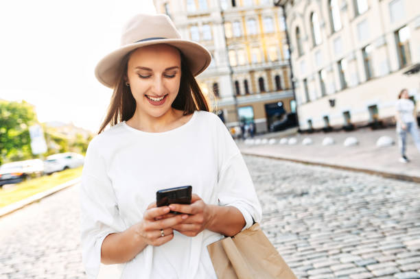 istock Pretty young woman in hat is chatting on the phone 1285497708