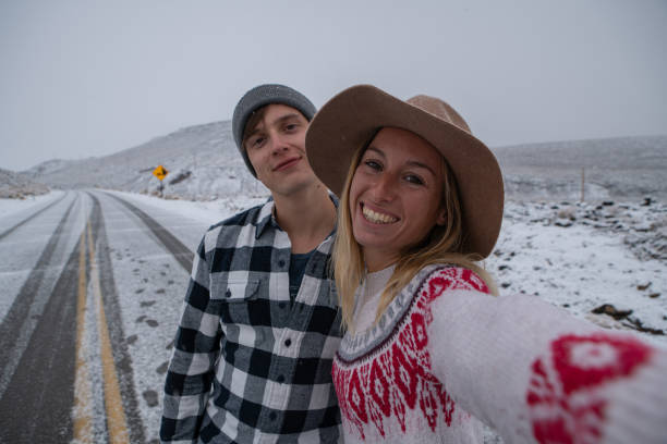 istock Couple takes selfie on empty road 1285498761