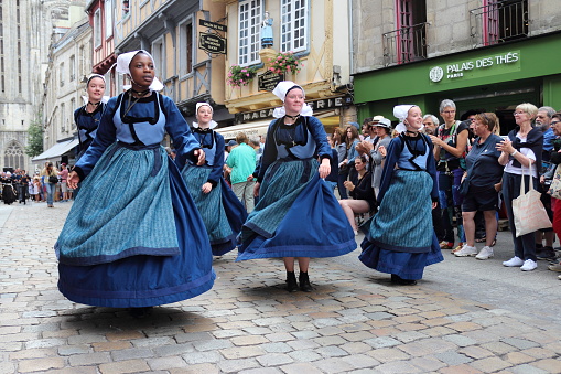 Quimper, Brittany/France- July 28, 2019 : The annual Festival de Cornouaille in the city of Quimper. People in traditional costumes dance to folk music.