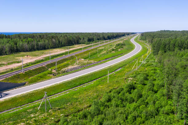 istock Highway, railway and power poles among the forest on the plain. 1285499907