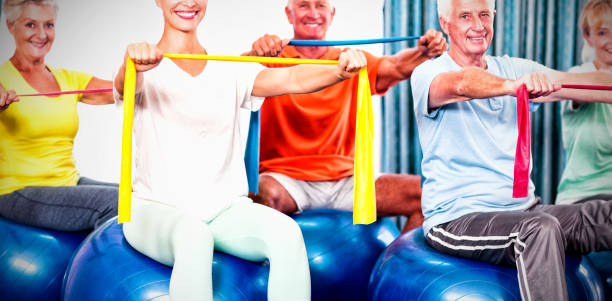 istock Portrait of seniors using exercise ball and stretching bands 1285500020