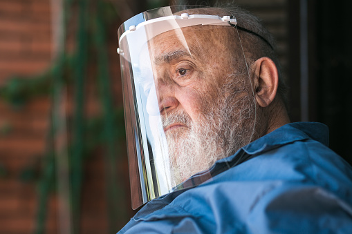 senior man wearing a protective visor