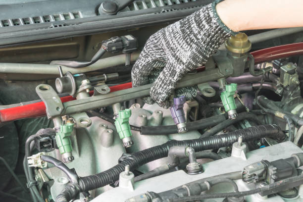 istock Car mechanic Checking fuel injector system, Car maintenance service. 1285501512