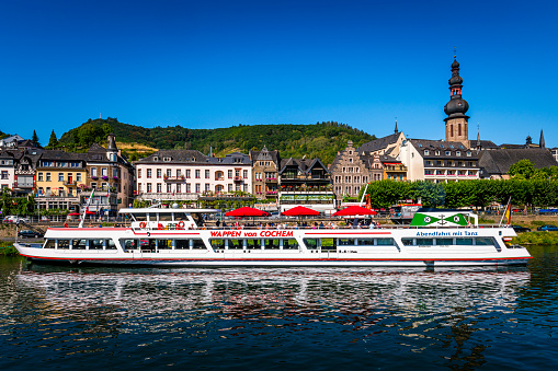 Cochem, Germany - August 07, 2020: Panoramic image of Cochem, Mosel River and a tourboat