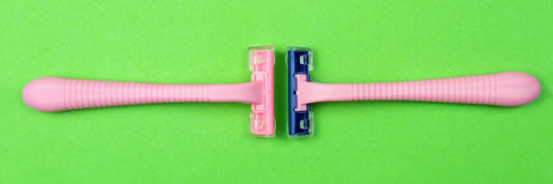 istock A pink disposable razor on a green . Personal hygiene items for shaving. 1285509736