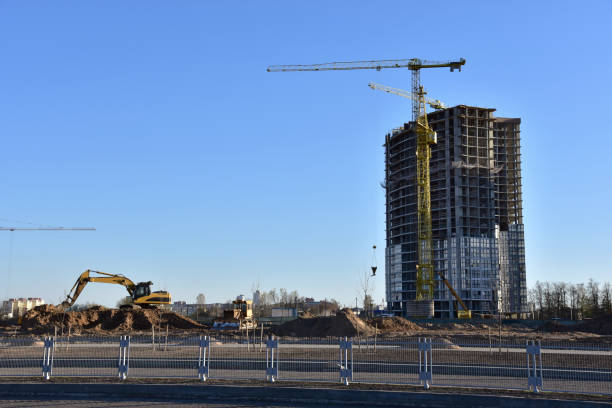 istock View on the large construction site with tower cranes and buildings. Excavator on Road work and earthworks for infrastructure improvement 1285509860