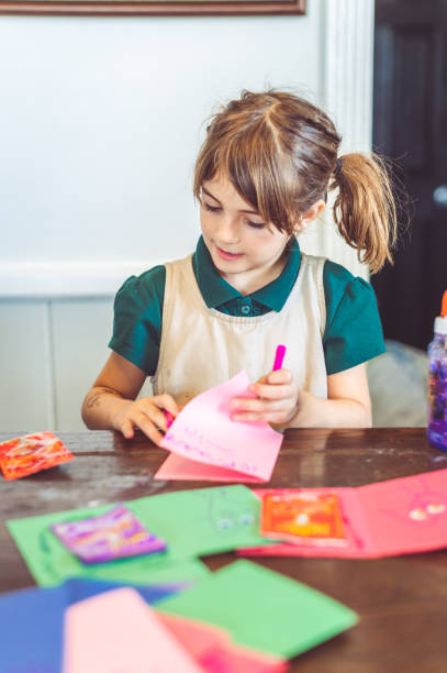 istock Girl works on art project or homework indoors 1285511655