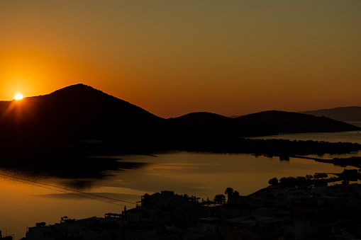 Sun rising above the mountains and the Aegean Sea on the Greek island of Crete