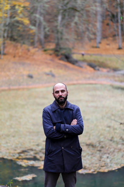 istock handsome man outdoors in fall clothing with autumn natural surroundings 1285512820