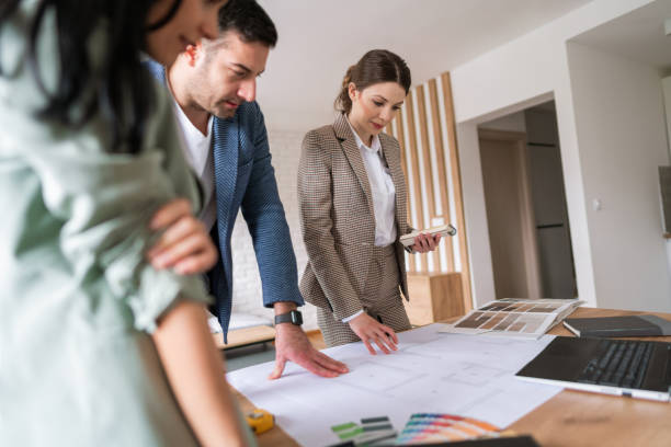 istock Female architect talking about a home interior with a young couple 1285512957