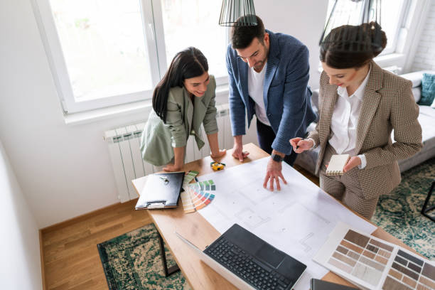 istock High angle view of a couple with an architect, talking about a home interior 1285512958