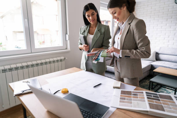 istock Female designer holding a color palette while her client making a choice 1285512965