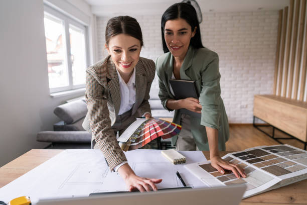 istock Smiling female designers working on interior ideas and using a laptop 1285513002