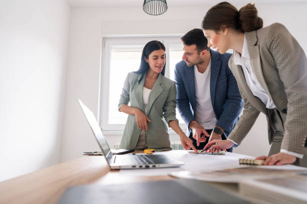 istock Couple and a female designer talking about home addition plans 1285513006