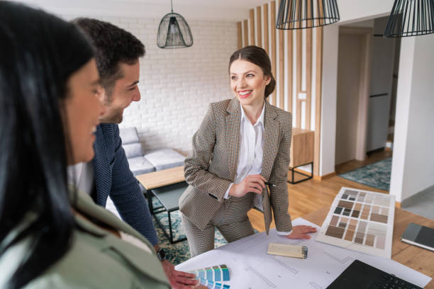 istock Smiling female designer talking with her clients 1285513020