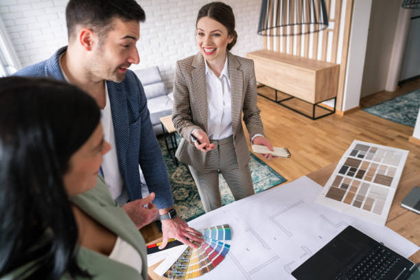 istock Happy female designer talking with her clients 1285513030