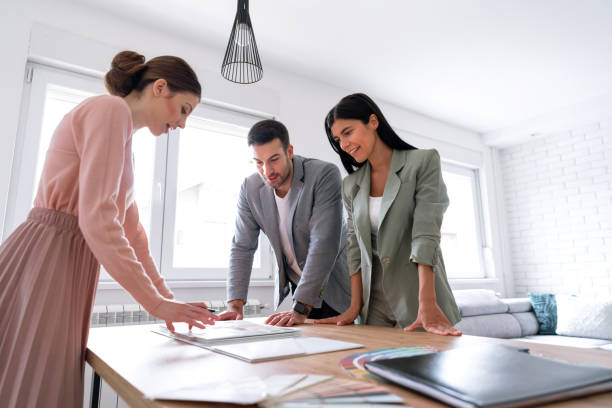 istock Young couple making some changes at home, meeting with interior designer 1285513041