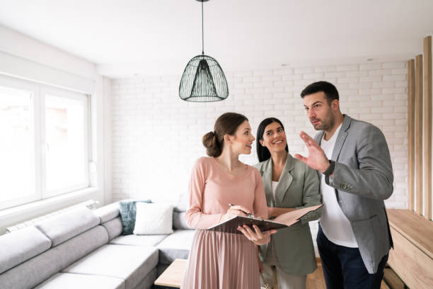 istock Young couple asking questions to a real estate agent 1285513140