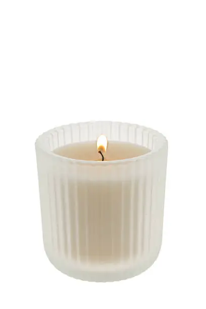 White candle in a clear glass container - white background
