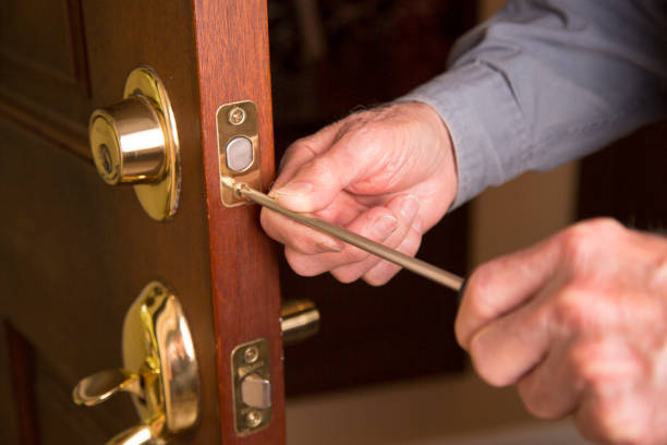 istock Worker or home owner installing or repairing new lock on doors. 1285513241