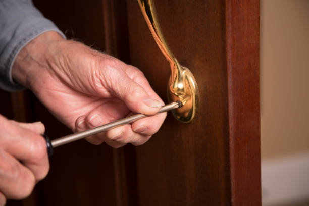 istock Worker or home owner installing or repairing new lock on doors. 1285513243